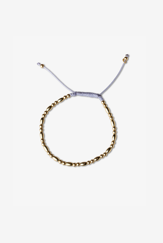 Pulseira em ouro amarelo com algodão lilás