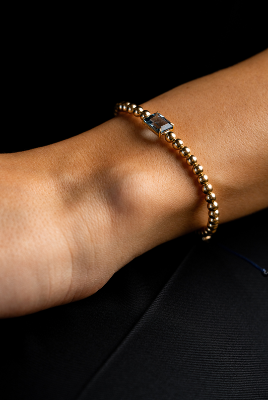 Pulseira em ouro amarelo com topázio azul.